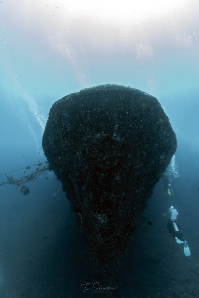 Liberty Shipwreck with divers and fish around Amed Bali