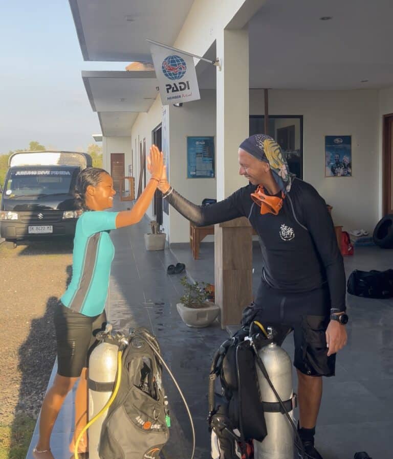 Scuba divers getting ready for a dive at Jukung Dive resort in Penida Bali Resort looking happy and proud