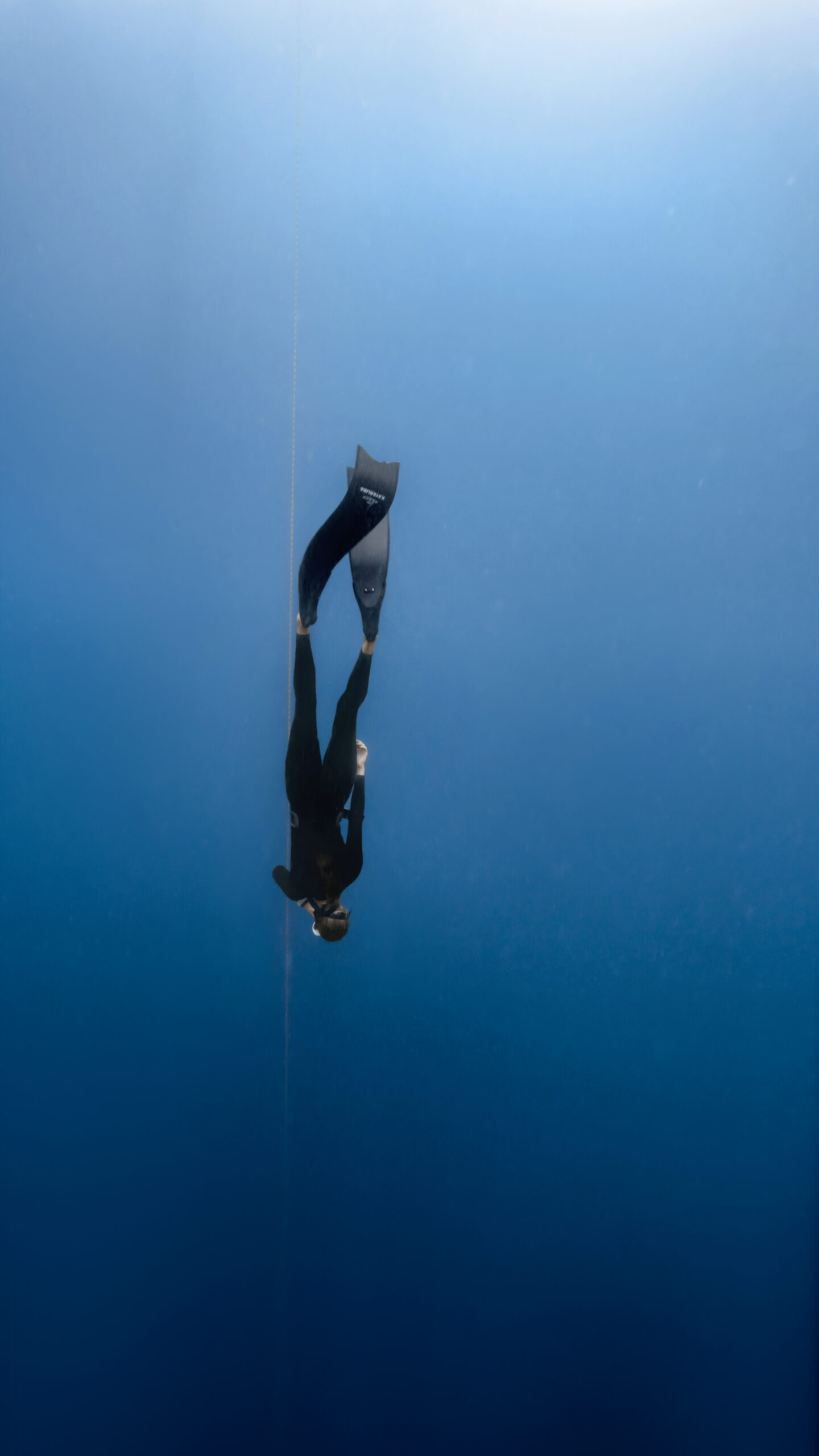 Advanced freediver descending on a dive line during AIDA 3 freediving training in Amed, Bali