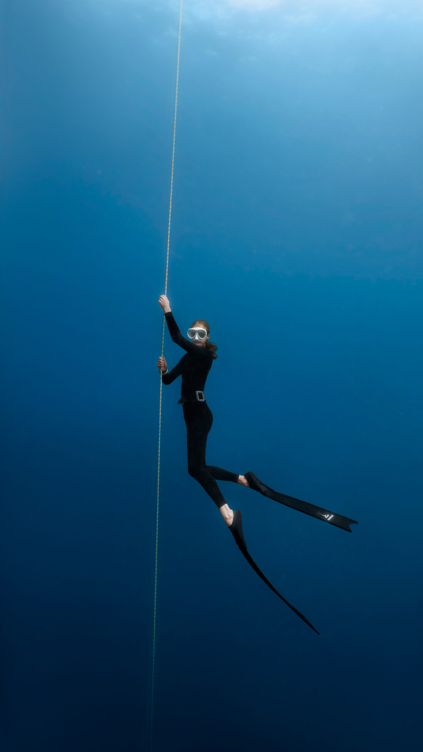 Beginner freediver practising line diving during an AIDA 1 freediving course in Amed, Bali