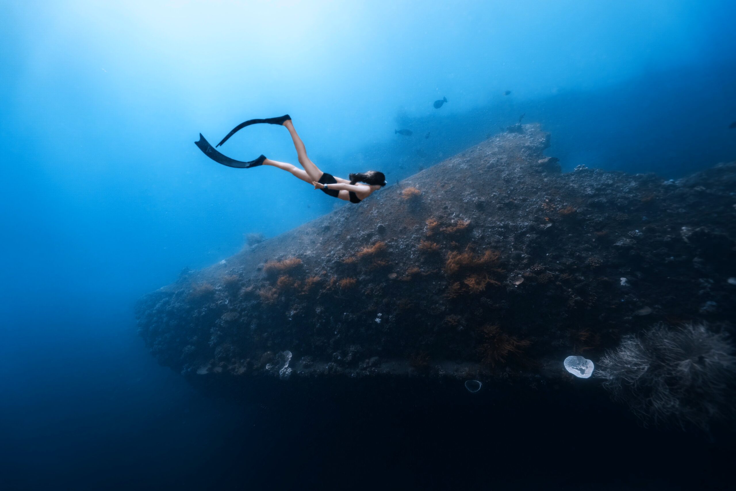 Free diver exploring the USAT Liberty Wreck as part of a Bali dive package with Jukung Dive