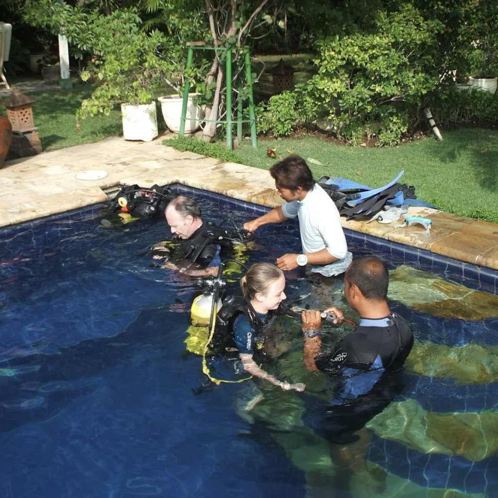 PADI scuba diving training session in the pool at Jukung Dive Amed Resort