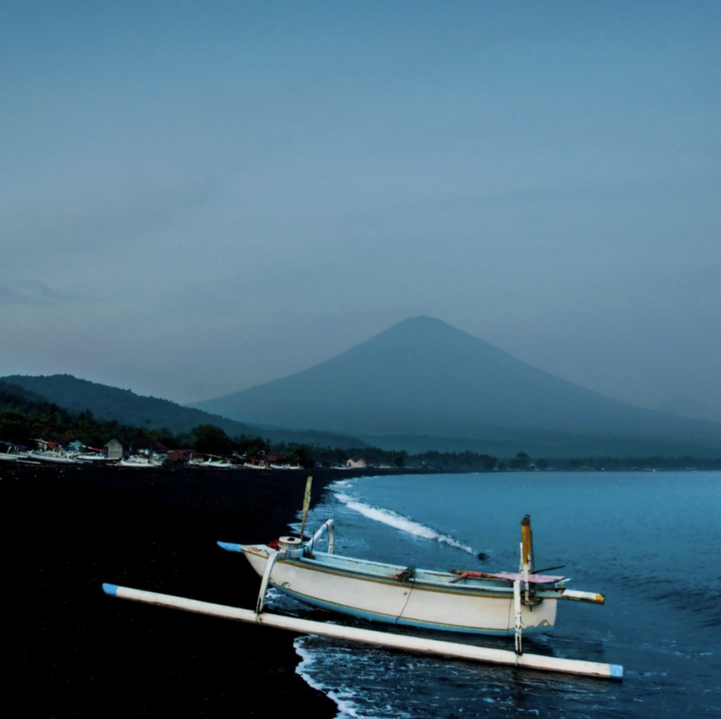 Traditional Indonesian jukung boat in Amed Bali with Mount Agung views