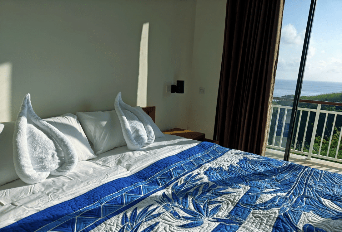 Twin Room with Sea View at Jukung Dive Resort Nusa Penida with two single beds, private sea-view balcony, and comfortable accommodation for dive buddies visiting Bali.