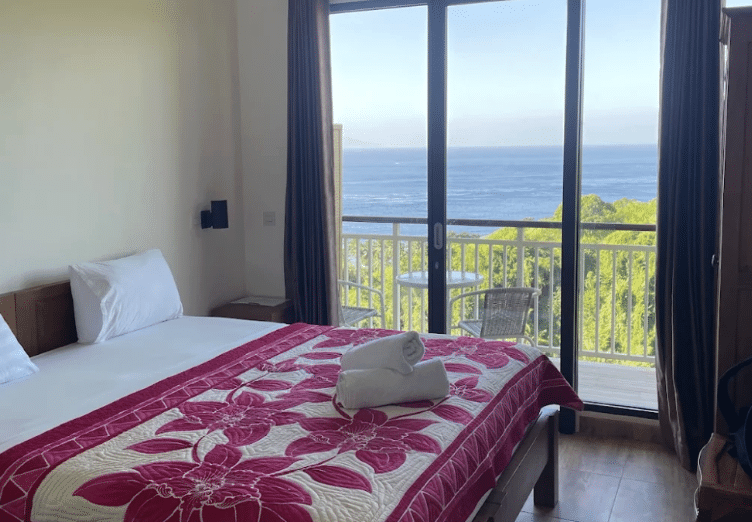 Double Room with Sea View at Jukung Dive Resort Nusa Penida featuring a private balcony, ocean views, comfortable double bed, and peaceful accommodation for divers visiting Bali.
