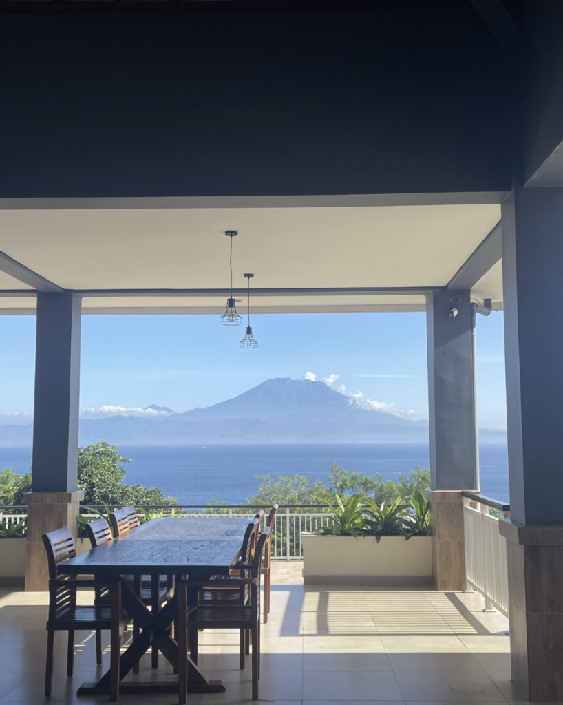 Sky Penida Rooftop Restaurant at Jukung Dive Resort Nusa Penida overlooking Mount Agung, offering panoramic ocean views and sunset dining in Bali.