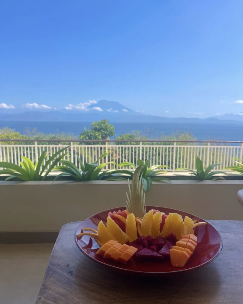 Fresh tropical fruit platter served at Sky Penida Rooftop Restaurant overlooking the ocean in Nusa Penida, Bali.