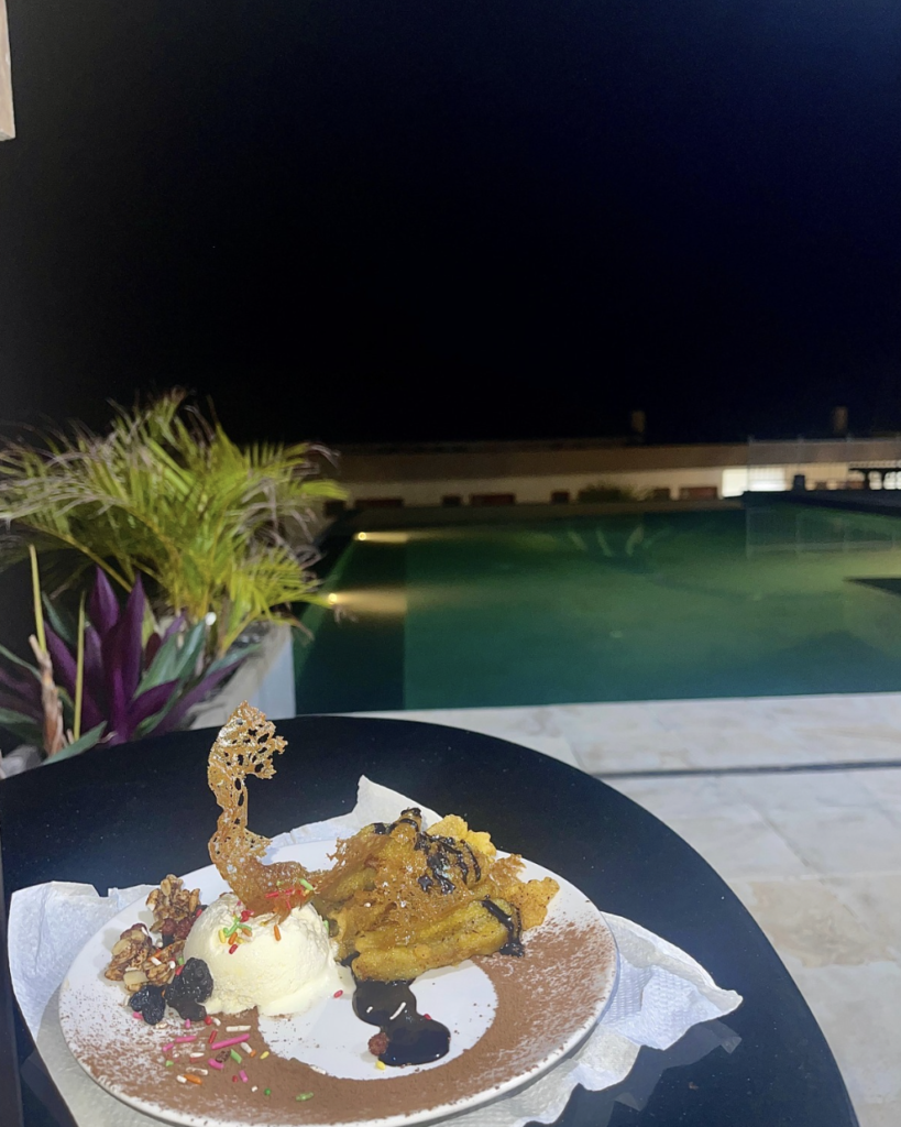 Dessert served beside the infinity pool at Jukung Dive Resort Nusa Penida with relaxing evening views in Bali.