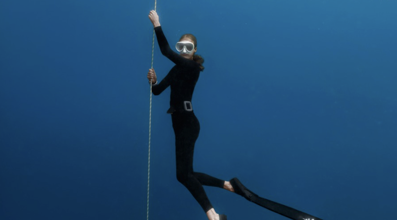 Freediver practising breath-hold techniques on a training line in the crystal-clear waters of Nusa Penida, Bali, preparing for freediving courses and underwater adventures.
