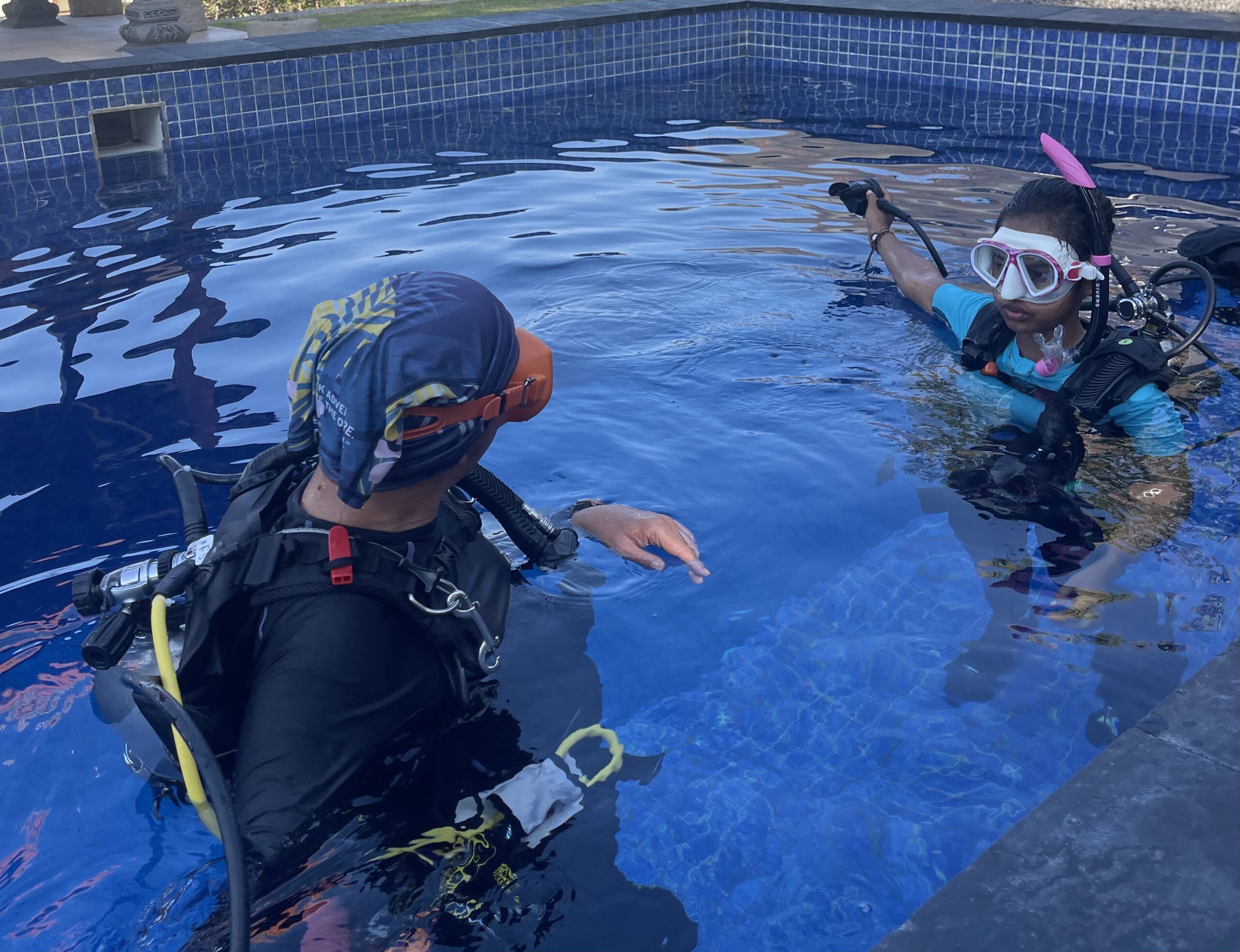 PADI Discover Scuba Diving student learning essential scuba skills with a professional instructor during a pool training session in Bali