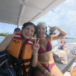 Two snorkelers on a boat in Nusa Penida smiling with Jukung Dive