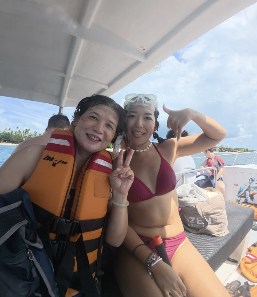 Two snorkelers on a boat in Nusa Penida smiling with Jukung Dive