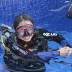 Happy DSD student in pool smiling in Nusa Penida