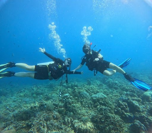 Two divers happy underwater in Amed